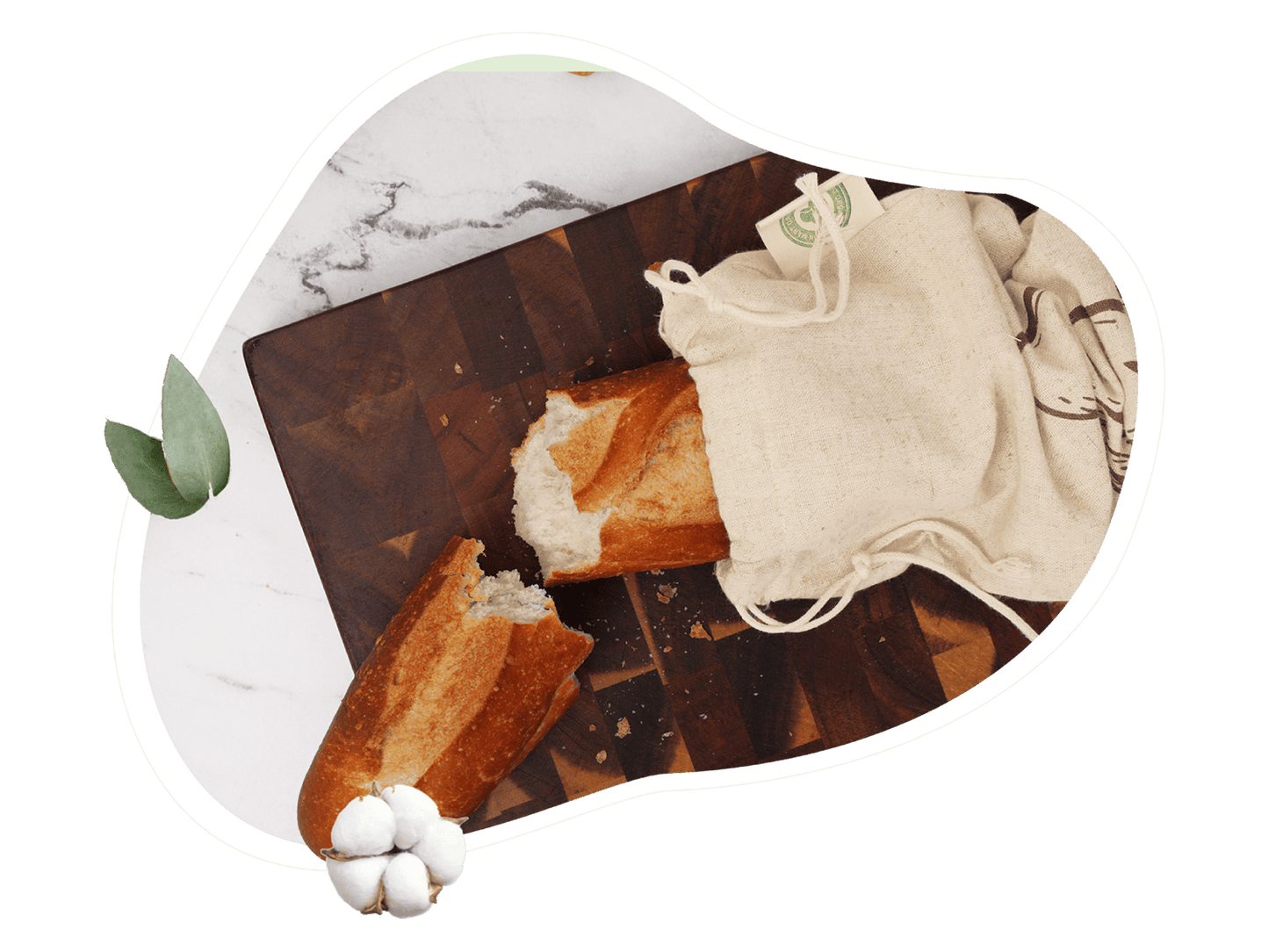 Loaf of bread on a cutting board with a piece cut off, next to a white cloth and money.