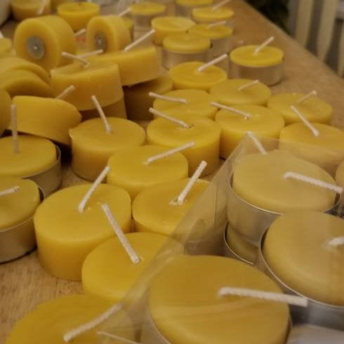 yellow beeswax tea light candles on a table