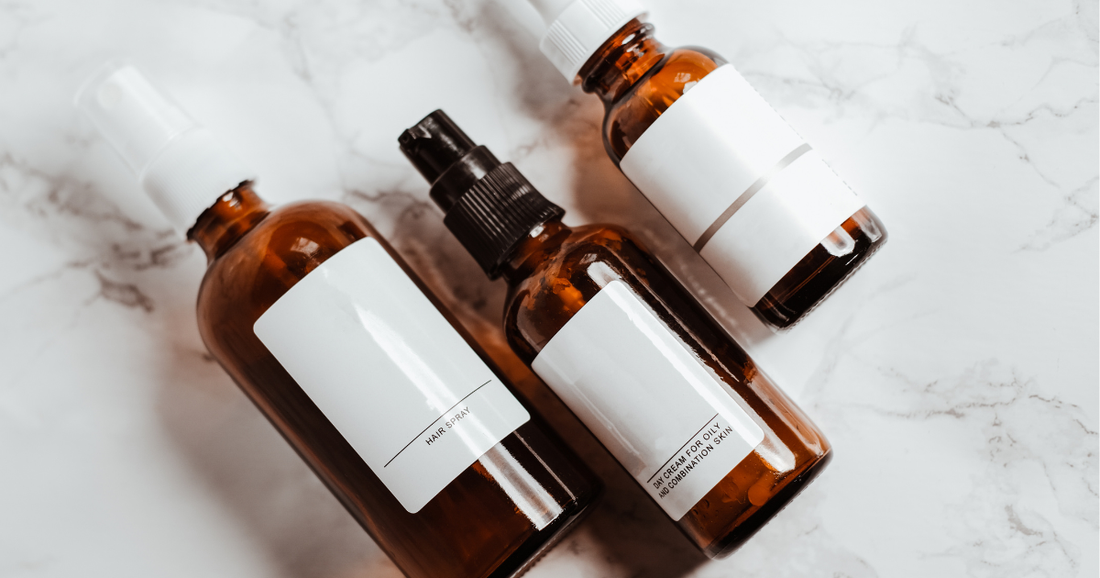 Flatlay of natural skincare bottles with ingredient label for learning how to read skincare labels.