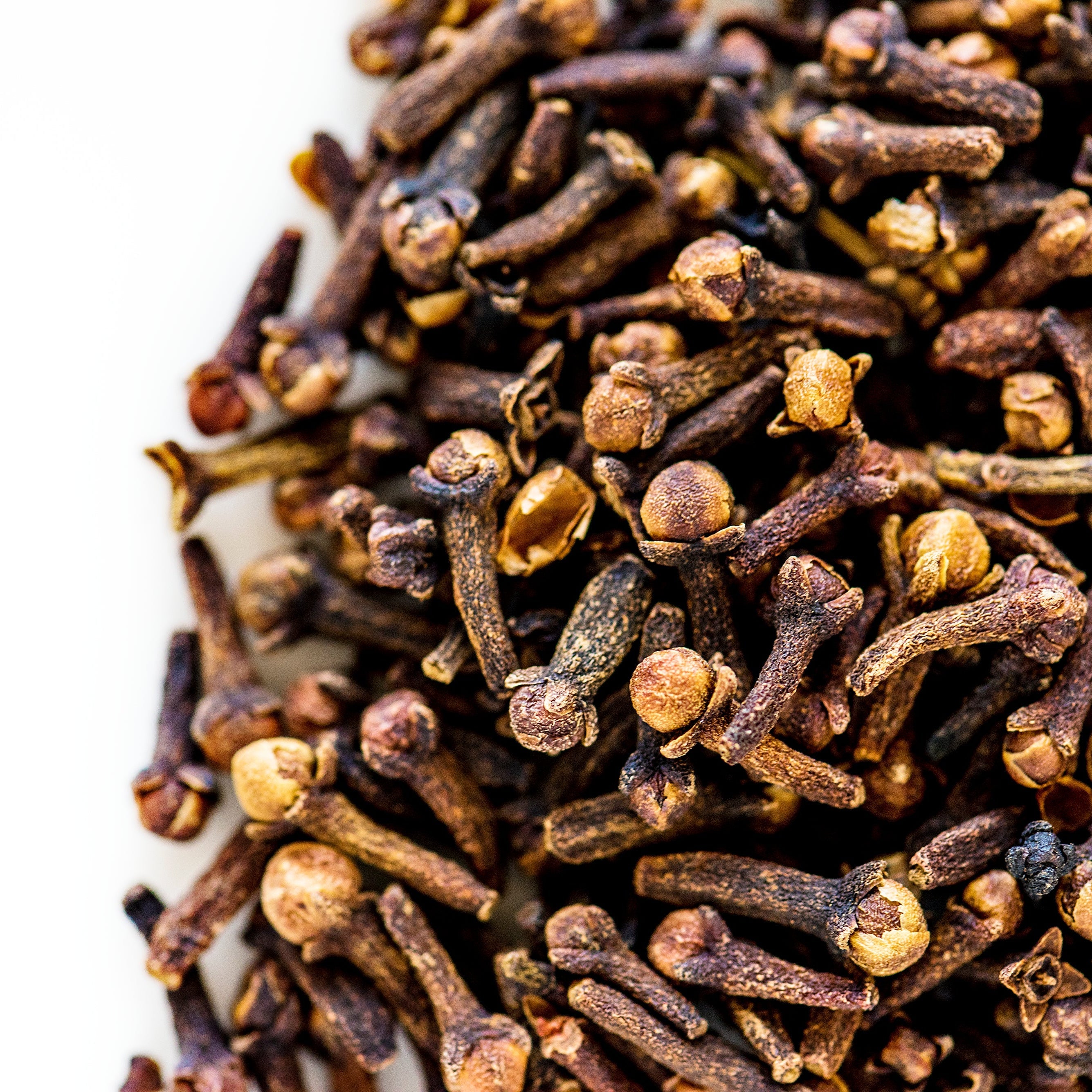 Close-up of dried cloves on a white background