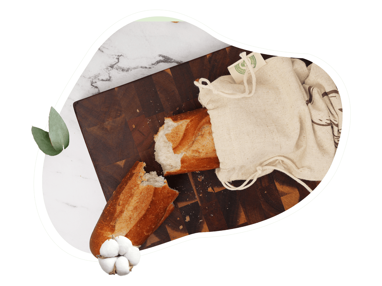 Loaf of bread on a cutting board with a piece cut off, next to a white cloth and money.