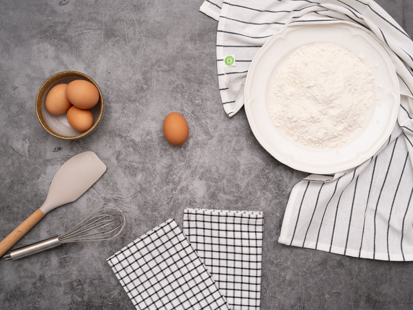 Baking ingredients and utensils on a gray surface