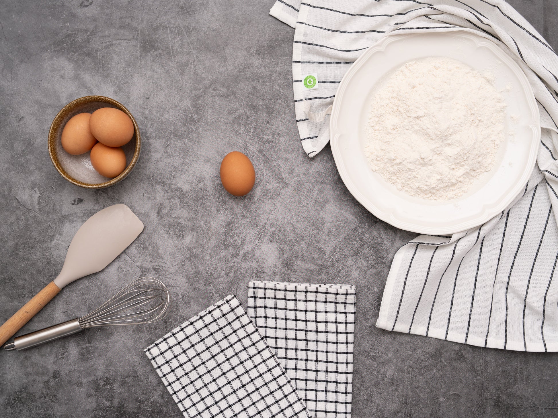 Baking ingredients and utensils on a gray surface