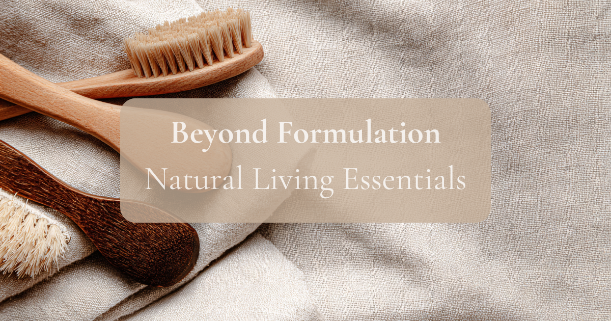 Wooden toothbrushes on a textured fabric background with 'Beyond Formulation Natural Living Essentials' text.