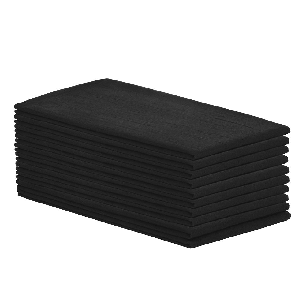 Stack of black folded towels on a white background