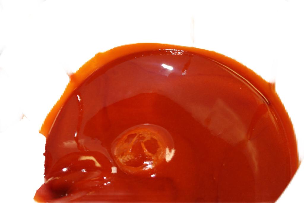 Close-up of red palm oil on a white background