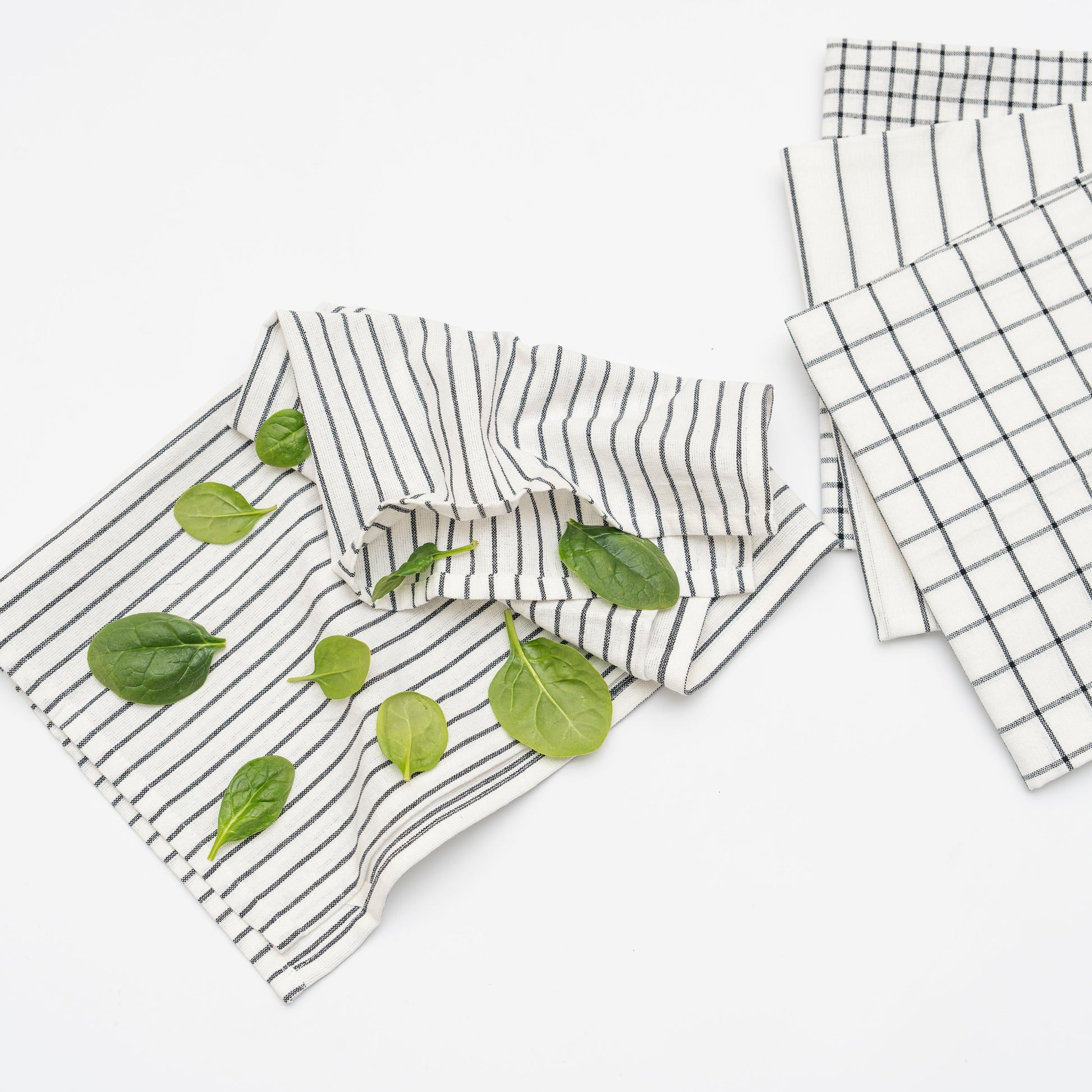 Set of kitchen towels with different patterns on a white background
