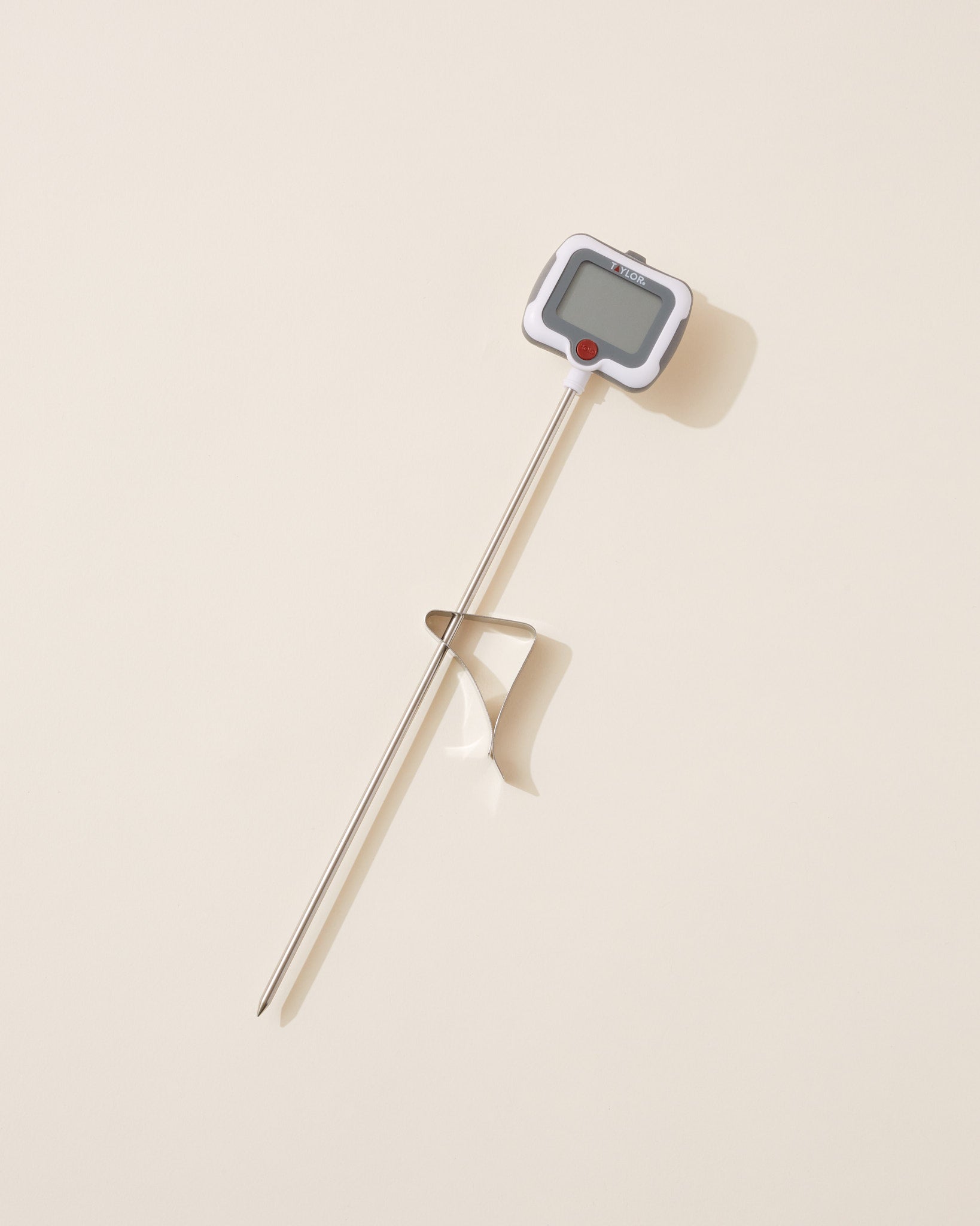 Digital thermometer on a beige background