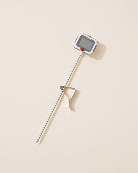 Digital thermometer on a beige background